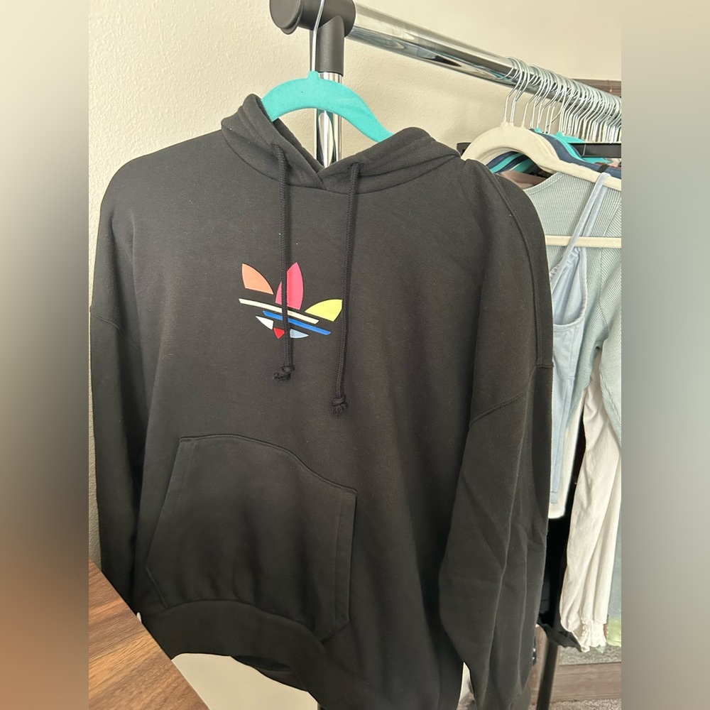 Brand new adidas sweater with tags. Fits more like a small/medium size sweater.
